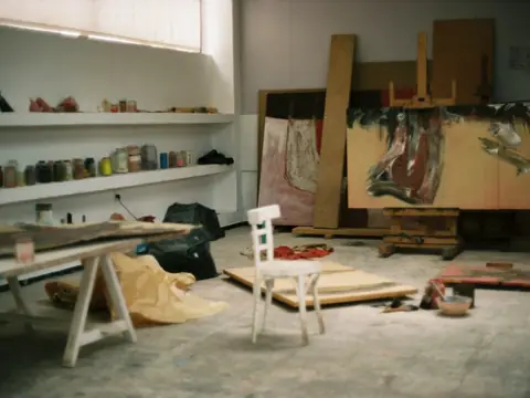 Artist studio with canvases, easels and supplies