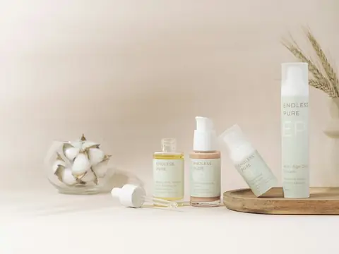 Skincare bottles and jars on a light table