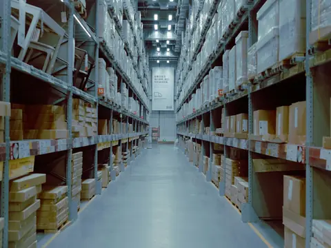 Warehouse aisle with tall shelves of boxed stock
